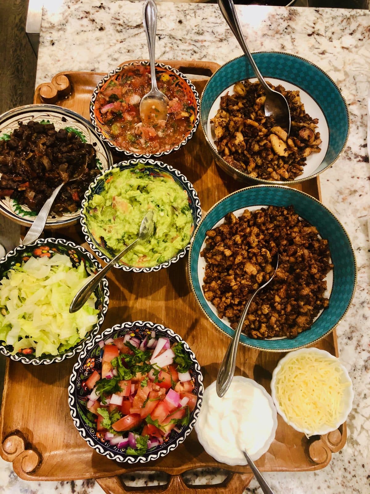 homemade taco spread with salsa, guacamole, and toppings
